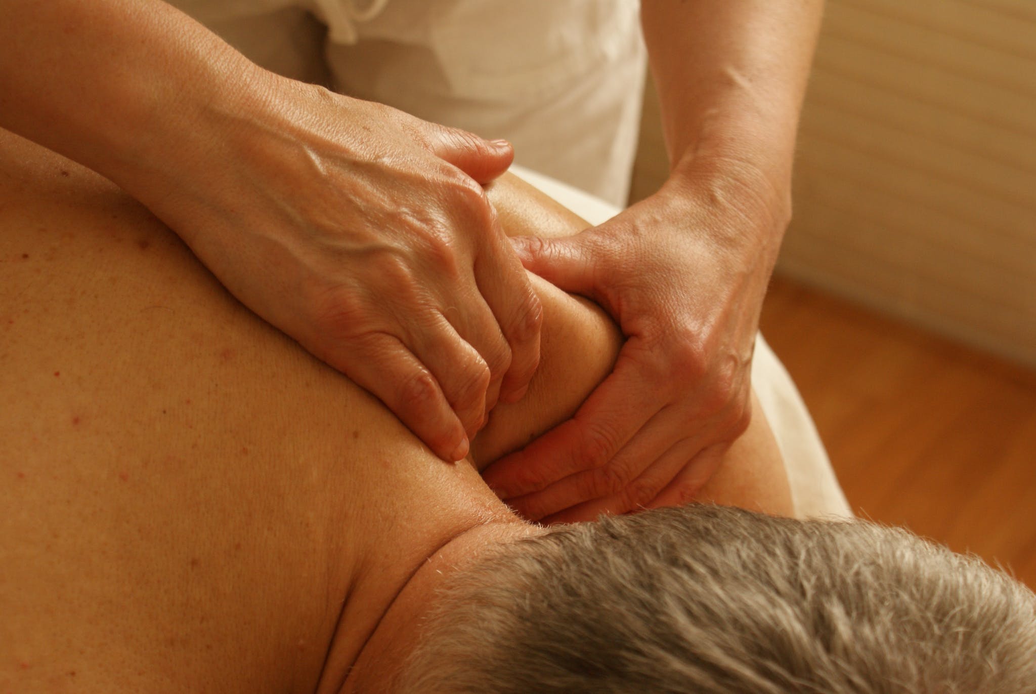Sports Massage Person Massaging Man's Shoulder