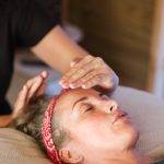 Relaxed woman getting Reiki