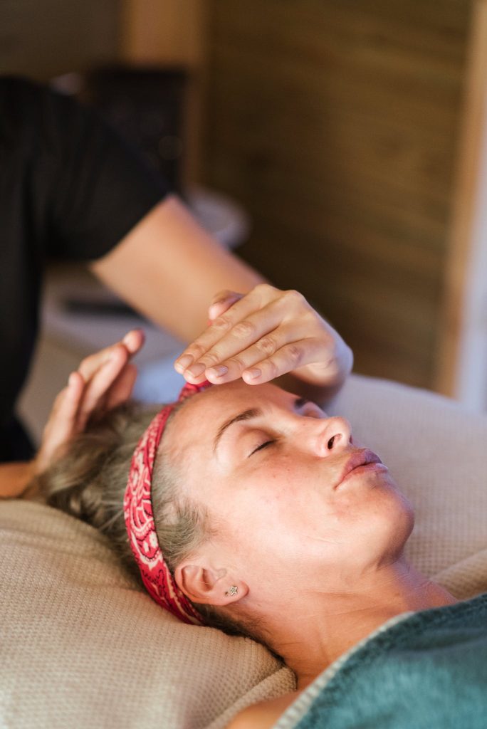 Relaxed woman getting Reiki